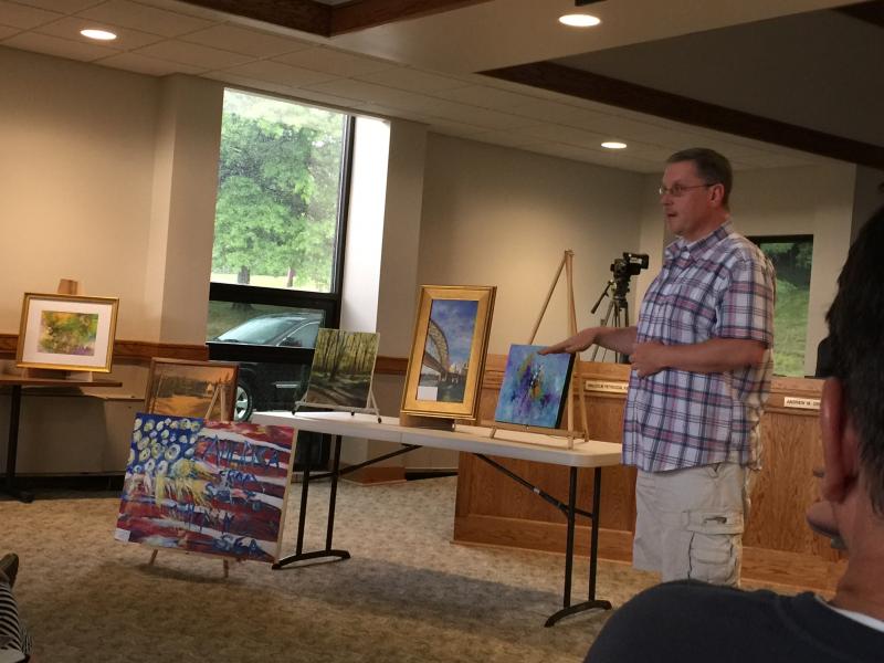 WH9.230102154_std Lance explaining why he chose the background for his Meek cabin painting.